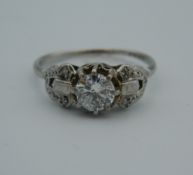 A platinum and diamond solitaire ring.