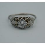 A platinum and diamond solitaire ring.