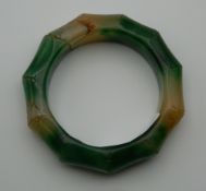 A jade carved faux bamboo bangle.