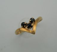 A 9 ct gold and sapphire wishbone ring. Ring Size L (1.