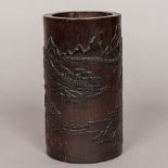 A Chinese carved stained bamboo brush pot Decorated in the round with figures,