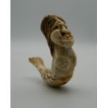 A 19th century Japanese carved ivory ojime formed as a mermaid. 4.5 cm long.