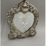 A silver framed heart shape mirror. 27 cm high.
