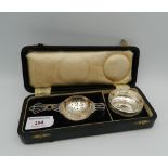 A boxed silver tea strainer and bowl (52 grammes total weight)