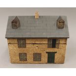 A wooden box formed as a house. 26 cm wide.