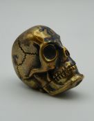 A brass vesta formed as a skull. 4 cm high.