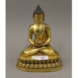 A gilt bronze model of Buddha. 22.5 cm high.