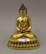 A gilt bronze model of Buddha. 22.5 cm high.