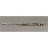 A three piece silver plated multi keyed flute. 67 cm long.