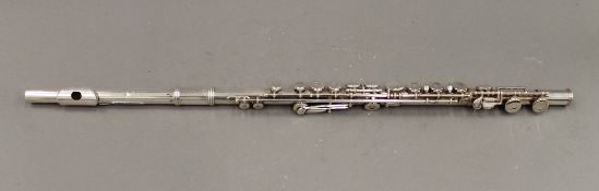 A three piece silver plated multi keyed flute. 67 cm long.