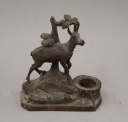 A Black Forest carved wooden inkwell surmounted with a goat. 14 cm high.