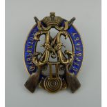 A Russian enamel decorated silver badge. 4.5 cm high.