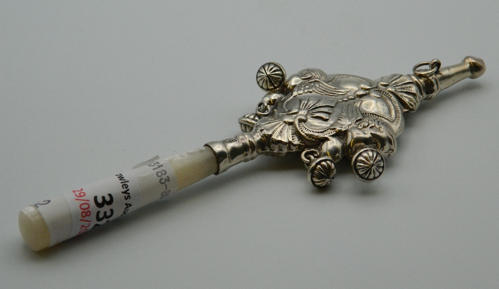 A silver and mother-of-pearl rattle. 16 cm long.