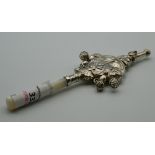 A silver and mother-of-pearl rattle. 16 cm long.