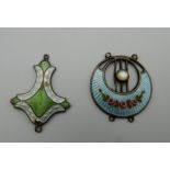 Two Art Nouveau enamel decorated silver pendants. The largest 3 cm high.