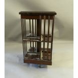 A modern mahogany revolving bookcase. 45 cm square.