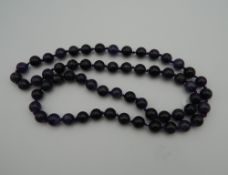 A string of amethyst beads. 69 cm long.