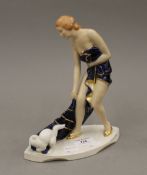 A Royal Dux porcelain Art Deco figure of a girl and her cat. 23 cm high.