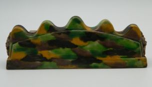 A Chinese green and yellow porcelain brush rest. 13.5 cm long.