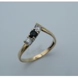 A 9 ct gold diamond and sapphire wishbone ring. Ring size M (1.