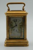 A miniature carriage clock set with porcelain panels. 9 cm high.