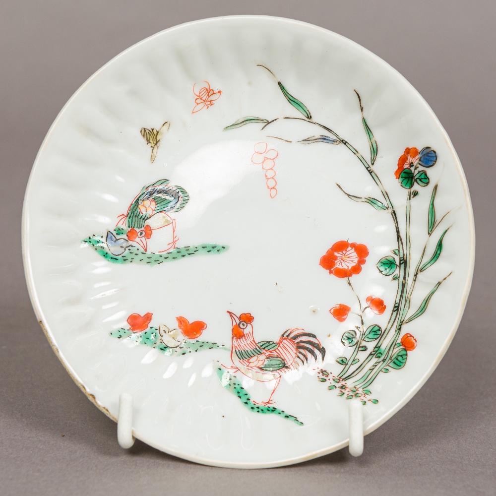 A small Japanese Kakiemon dish Decorated with chickens, butterflies and floral sprays.