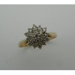 A 9 ct gold diamond daisy ring. Ring Size P/Q (2.