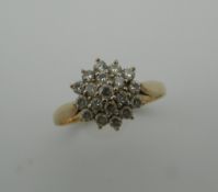 A 9 ct gold diamond daisy ring. Ring Size P/Q (2.