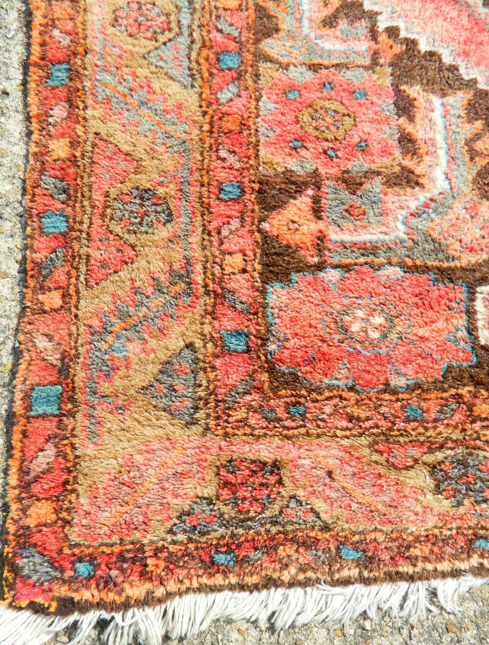 A Persian red ground wool rug. 200 x 128 cm. - Image 2 of 3