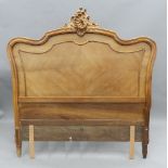 A 19th century French walnut headboard. 151 cm wide.