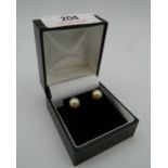 A pair of 9 ct gold pearl earrings. 6 mm diameter.