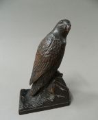 A Black Forest carved wooden model of a bird of prey. 16.5 cm high.