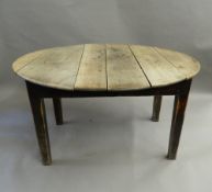 A 19th century oak topped oval kitchen table. 127 cm long, 72 cm high.