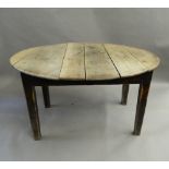 A 19th century oak topped oval kitchen table. 127 cm long, 72 cm high.