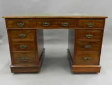 A Victorian walnut pedestal desk. 122 cm wide.