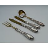 A four piece silver and silver gilt entremets set. The largest 18 cm long (129.