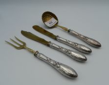 A four piece silver and silver gilt entremets set. The largest 18 cm long (129.