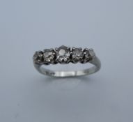 A platinum five stone diamond ring. Ring Size H/I, shank spilt (3.