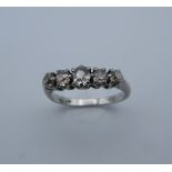 A platinum five stone diamond ring. Ring Size H/I, shank spilt (3.