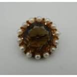 A 9 ct gold smoky quartz and cultured pearl brooch. 2.5 cm diameter (7.