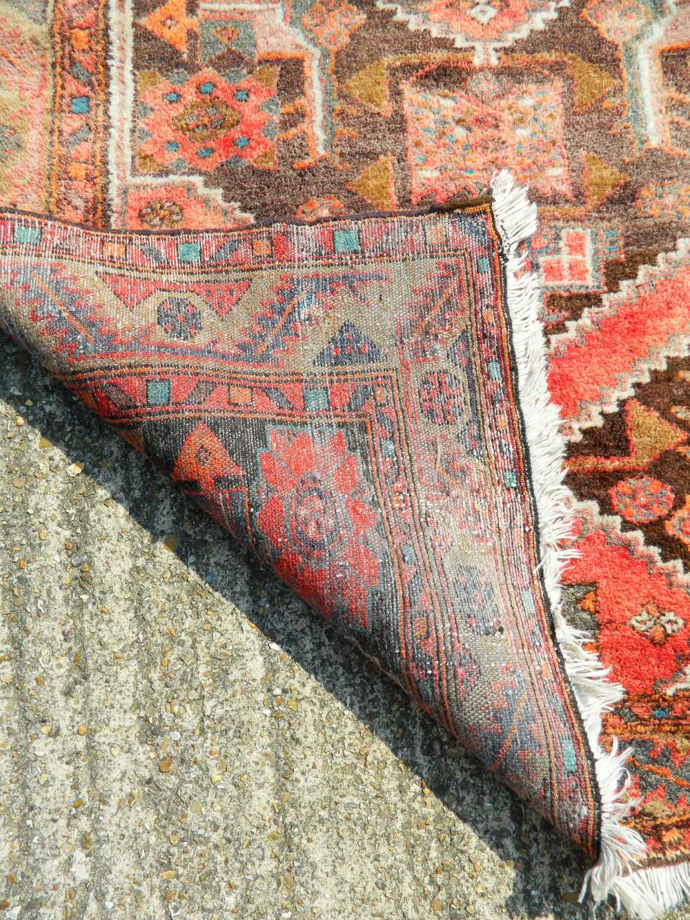 A Persian red ground wool rug. 200 x 128 cm. - Image 3 of 3