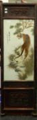 A Chinese porcelain plaque decorated with tigers, foliage and calligraphy, framed.