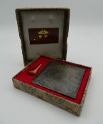 A boxed Chinese model of an ancient compass.