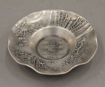 A Chinese white metal dish. 11 cm diameter.