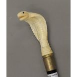 A walking stick with a carved bone handle formed as a cobra. 89 cm long.