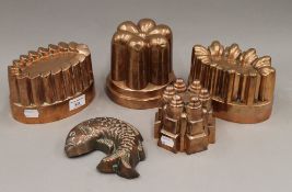 Four Victorian copper jelly moulds and another copper fish form mould. The largest 11.5 cm high.