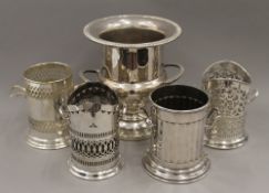 Four silver plated bottle coasters and a silver plated ice bucket. The latter 25.5 cm high.