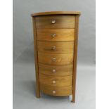 A modern slender bowfront chest of drawers.