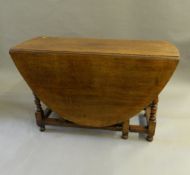 A large oak drop-leaf table. 118 cm wide.