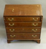 A George III oak bureau. 94 cm wide.